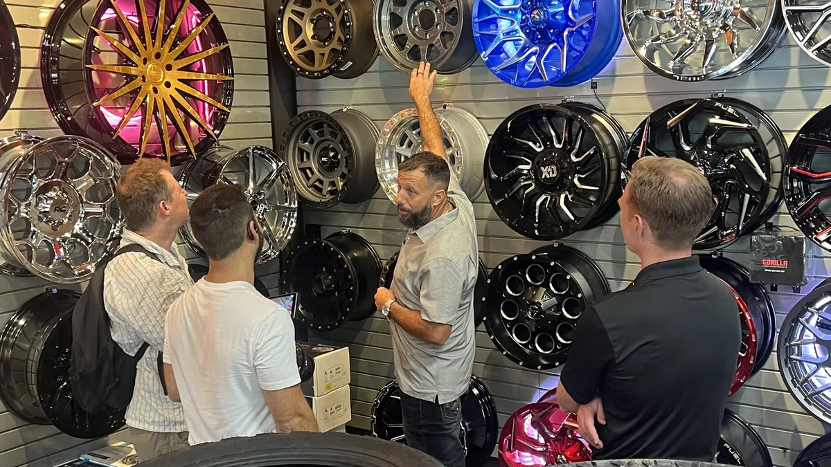 A restyler guides a customer through a professional wheel and tire decision